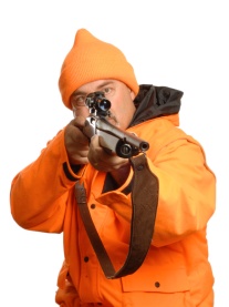hunter pointing rifle in blaze orange gear